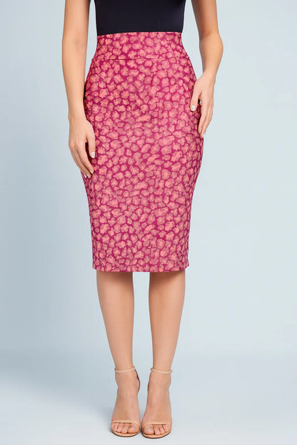 Woman wearing a pink leopard print tango skirt on a light gray background