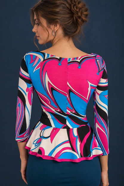Back view of a colorful abstract print viscose jersey tango top with three-quarter sleeves and a flared peplum.