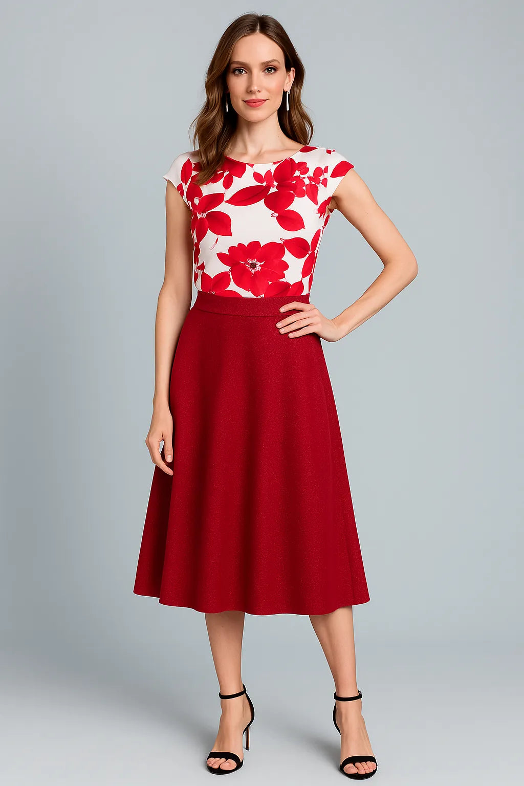 Woman wearing a red and white floral tango top with a red tango skirt on a gray background