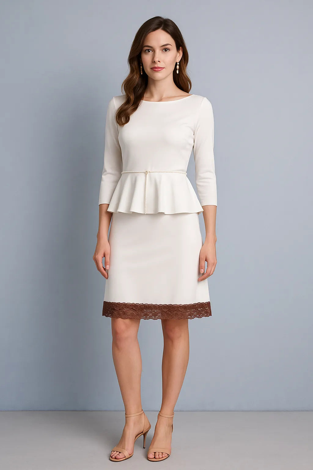 Woman wearing a white peplum tango top and tango skirt with brown lace trim against a gray background