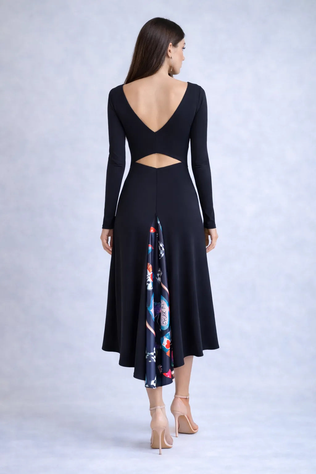 Woman wearing a black tango dress with a colorful back panel
