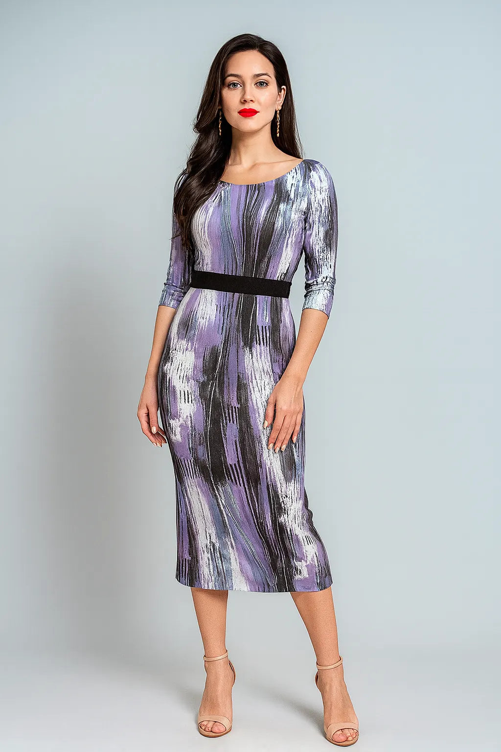 Woman wearing a patterned tango dress with a plain background