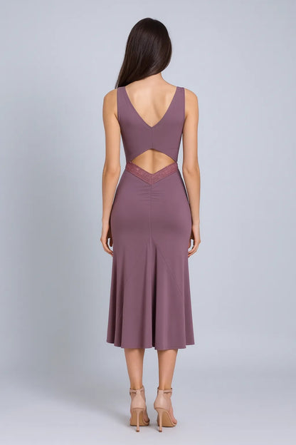 Woman wearing a mauve tango dress with cut-out design on a gray background