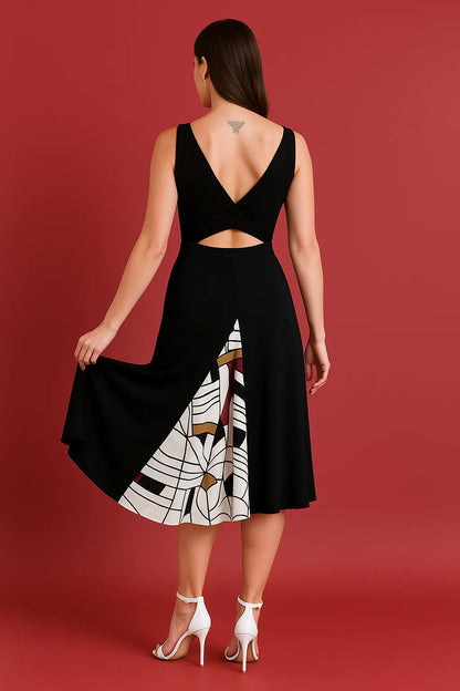 Woman wearing a black tango dress with a unique cutout design on a red background