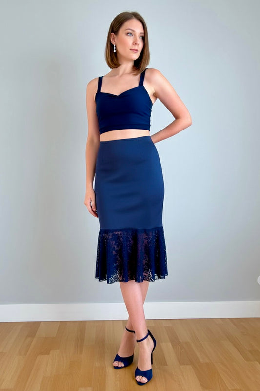 Woman wearing a navy blue tango top and skirt with lace hem