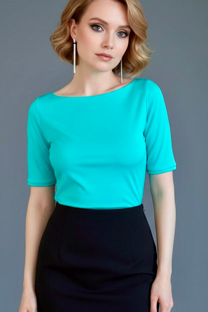 Woman wearing a turquoise tango top and black skirt