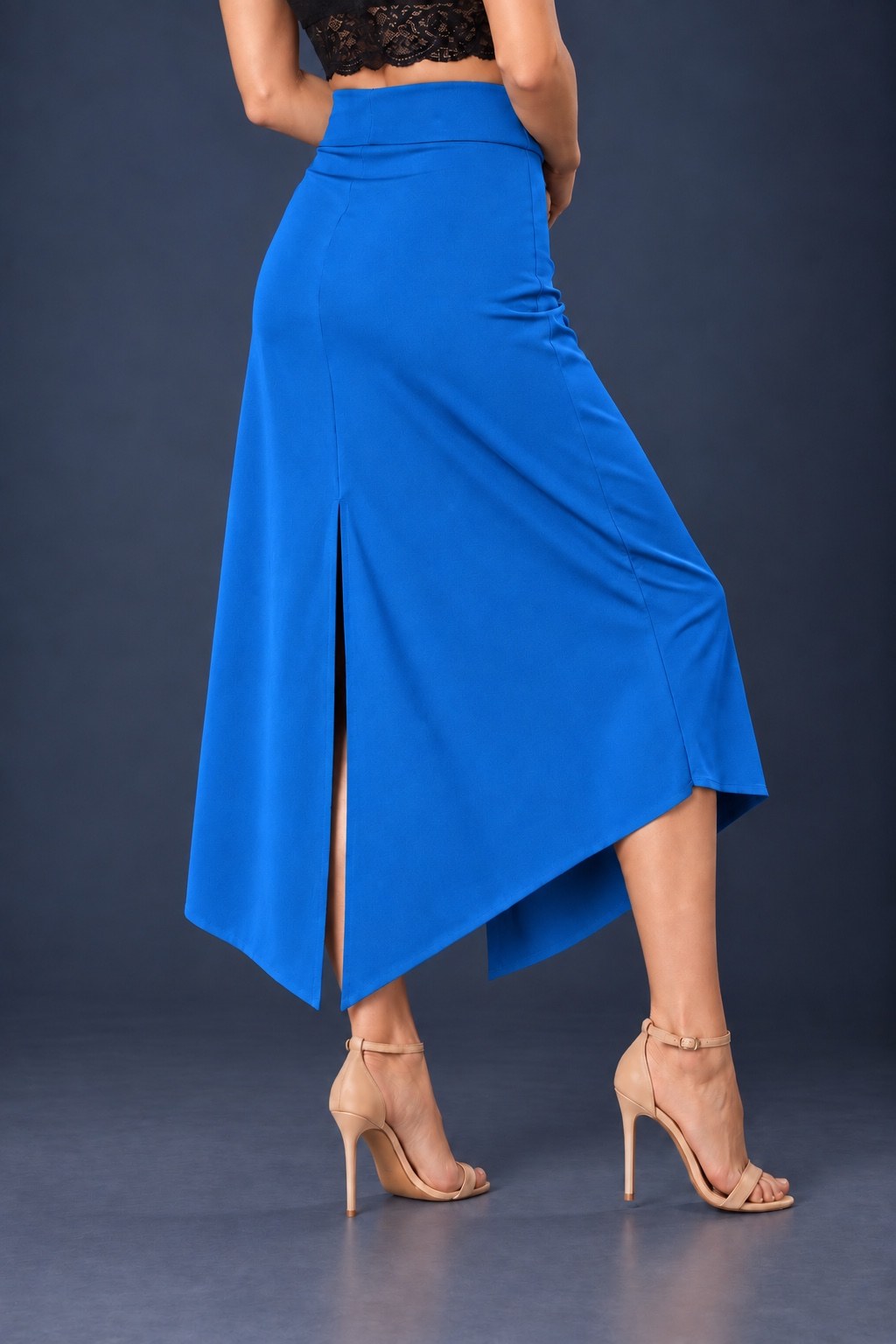 Back view of blue asymmetric jersey tango skirt with wide waistband, back slit and angled hem.