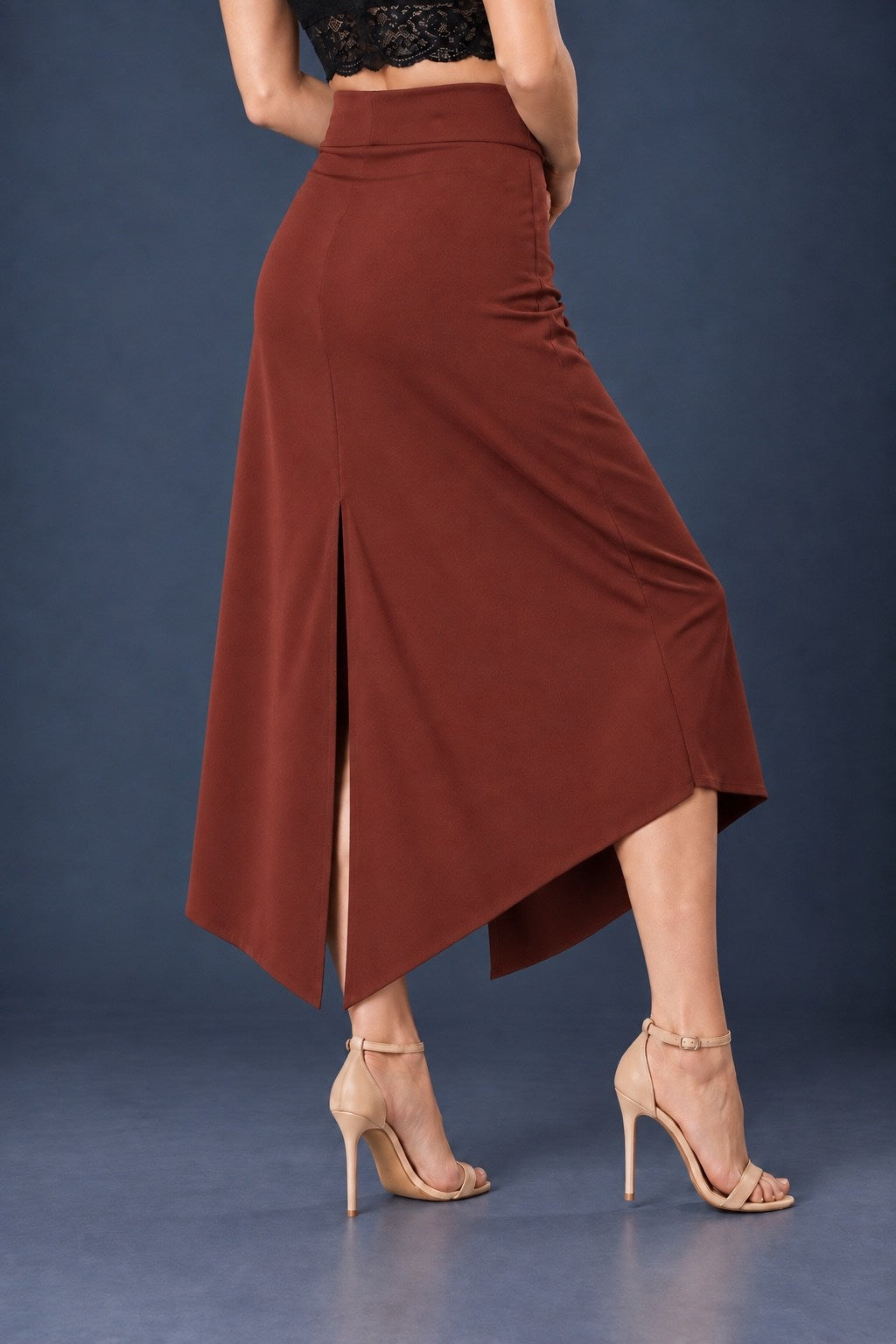 Back view of brown asymmetric jersey tango skirt with wide waistband, back slit and angled hem.