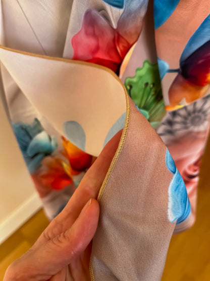 Close-up of a hand holding a colorful fabric of a wrap tango skirt