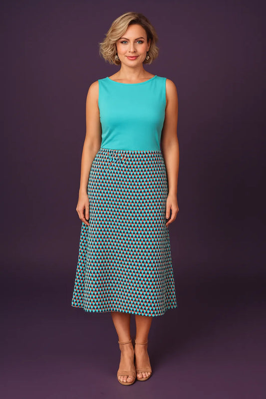 Woman wearing a turquoise sleeveless tango top and patterned tango skirt