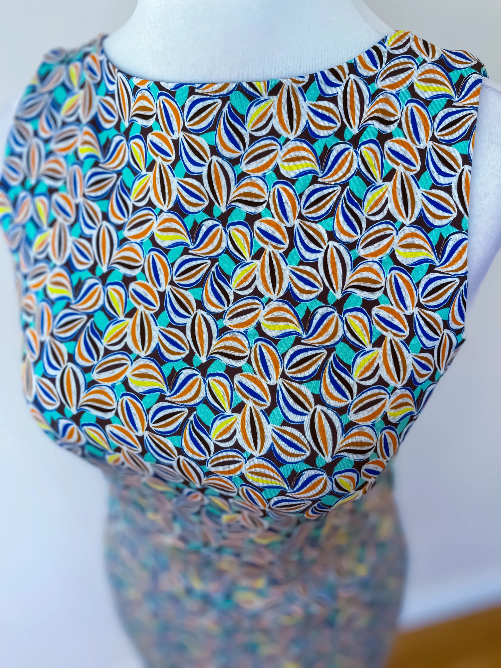 Mannequin wearing a colorful patterned tango top, front view