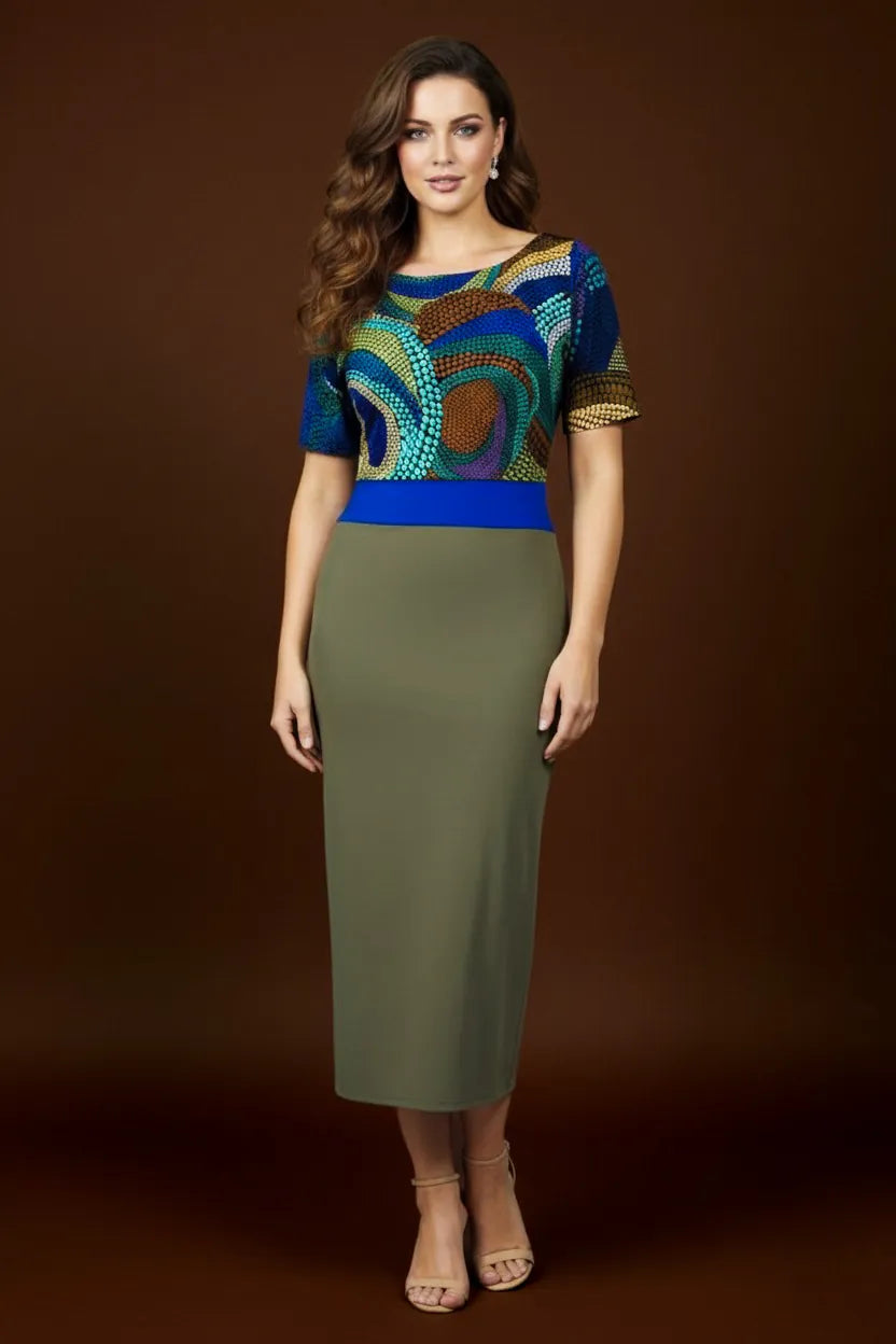 Woman wearing a tango dress with colorful top and green skirt