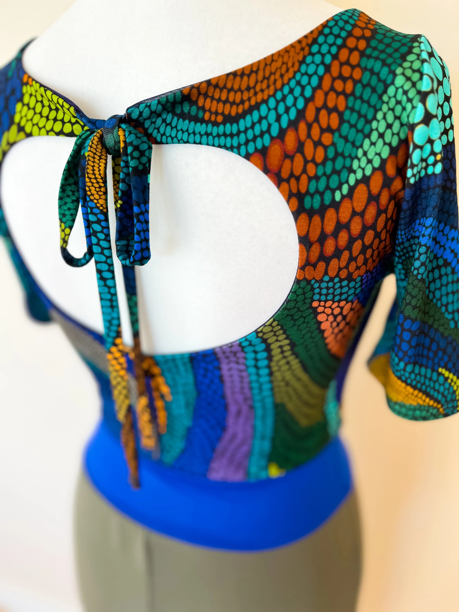 Colorful patterned tango dress on a mannequin, back view