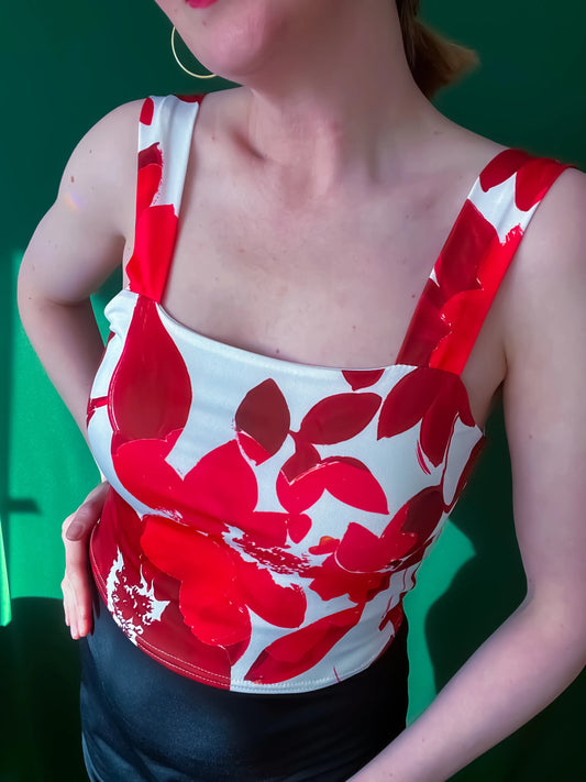 Woman wearing a red and white floral tango top, close up of a tango set