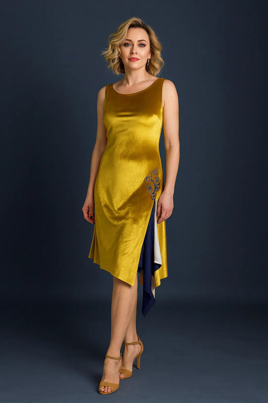 Woman wearing a golden velvet tango dress with a dark background, front view