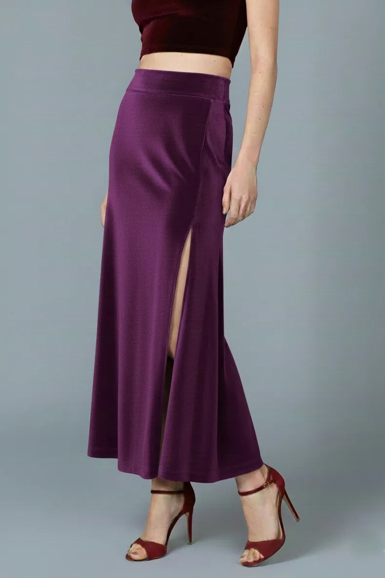 Woman wearing a purple velvet tango skirt with a high waist