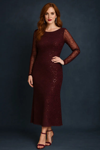 Woman wearing a deep bordeaux tango dress with sheer sleeves against a dark background