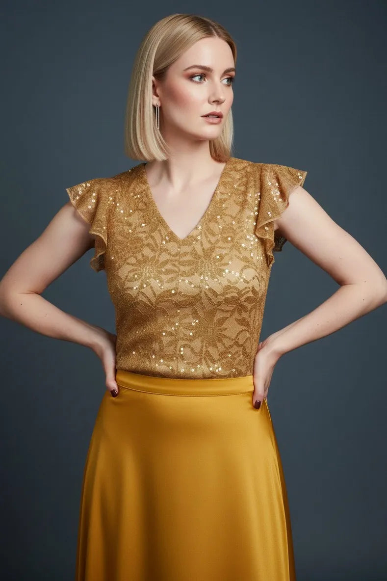 Woman wearing a golden lace tango top, front view