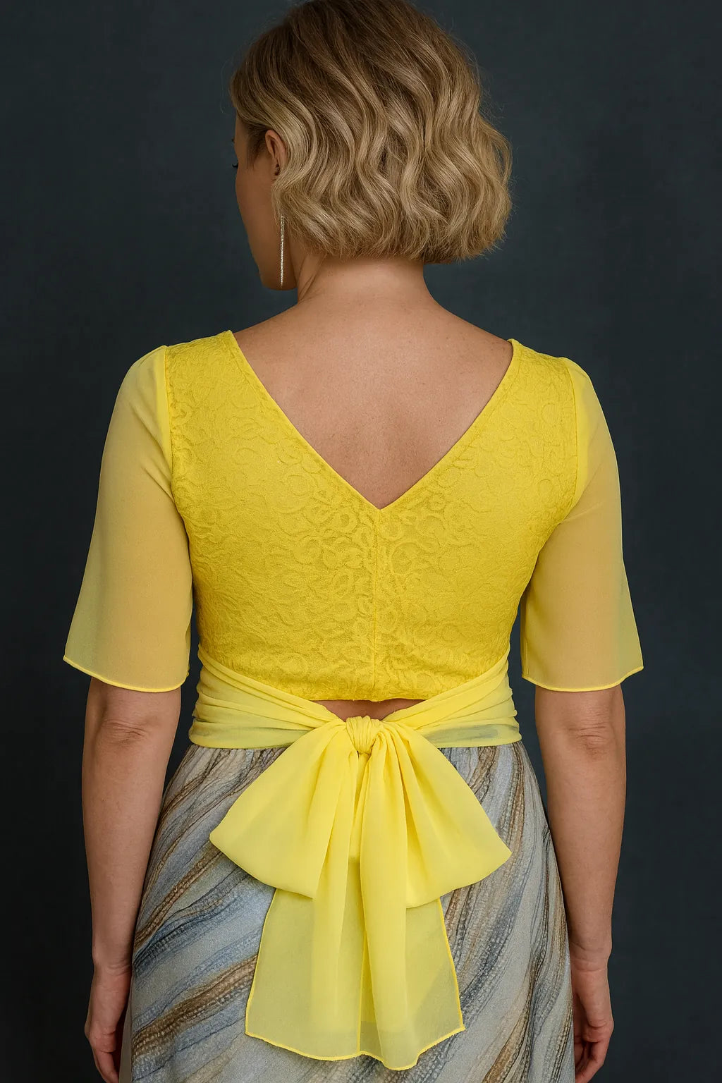 Woman wearing a yellow lace tango top, back view