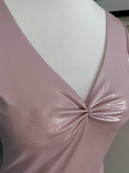 Woman wearing a shimmering pink jersey tango top with a deep V-neckline, gathered bust and flutter sleeves, front view.