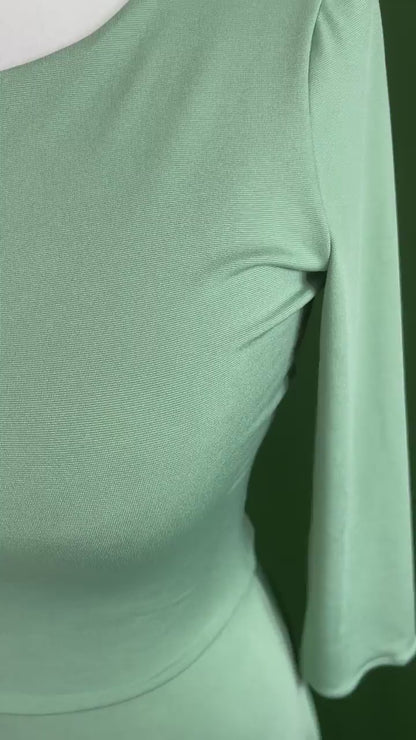 Striking pistachio dress with fitted bodice and dramatic back