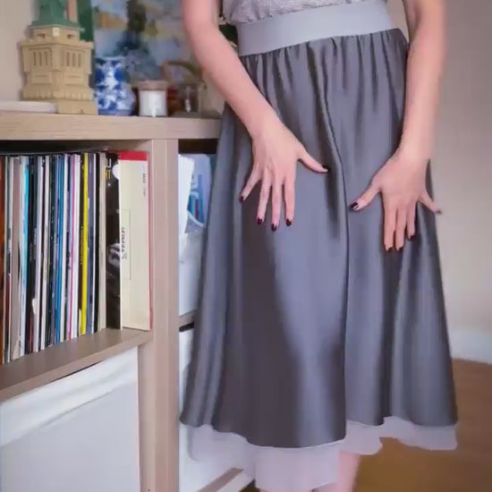 Video of a woman in two layer flowing grey tango skirt