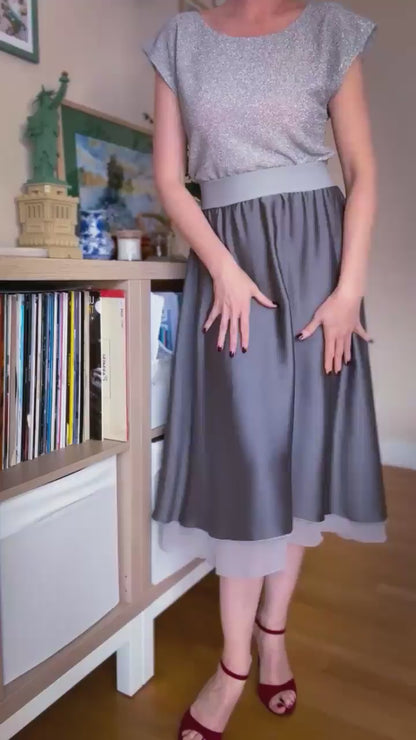 Video of a woman in two layer flowing grey tango skirt