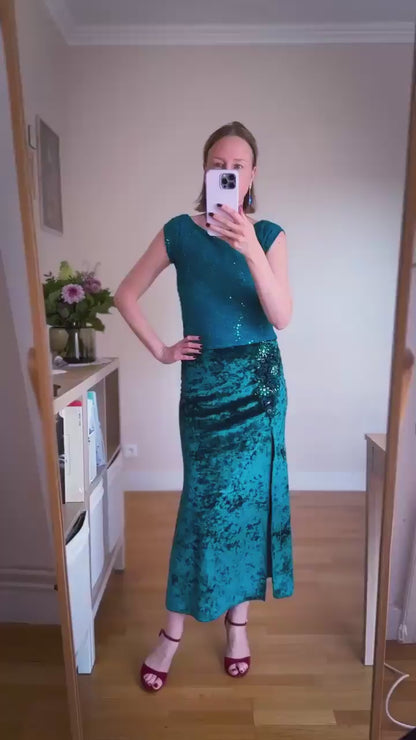 Video of a woman wearing a teal velvet tango skirt