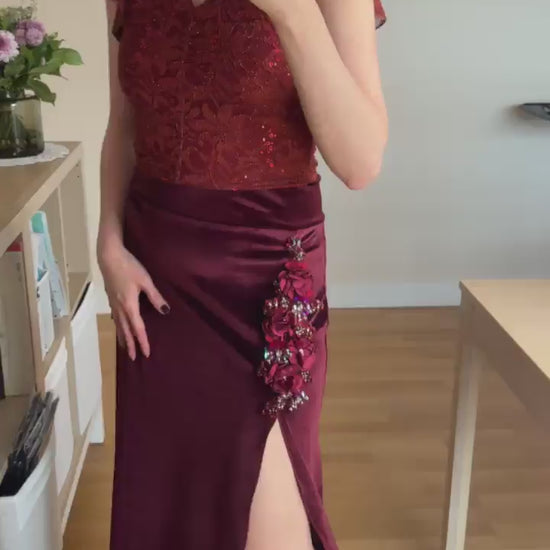 Video of a woman wearing a burgundy lace tango top and brown tango skirt