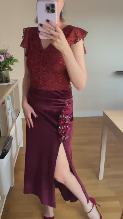 Video of a woman wearing a burgundy lace tango top and brown tango skirt