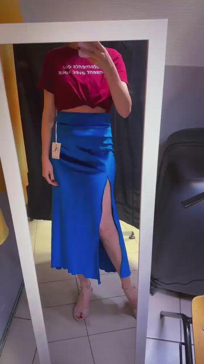 Woman in blue velvet tango skirt in front of the mirror