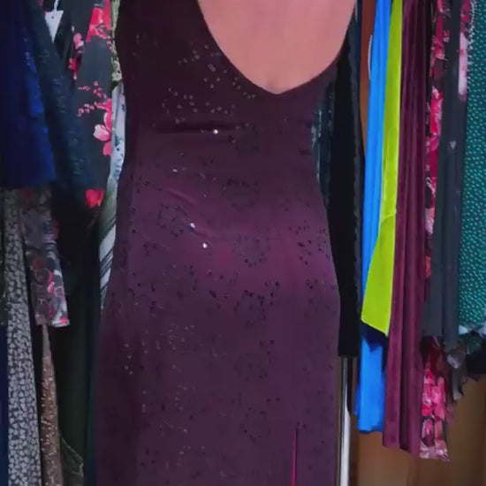 Video of a woman wearing an elegant bordeaux tango dress with shimmering embroidery