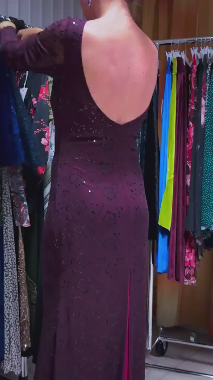 Video of a woman wearing an elegant bordeaux tango dress with shimmering embroidery