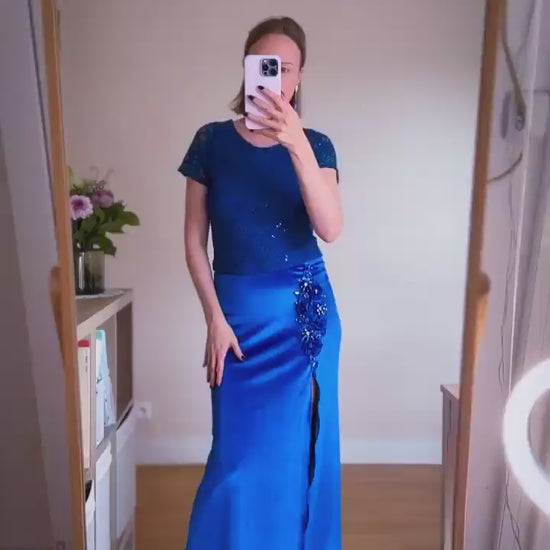 Woman wearing a blue velvet tango skirt with embroidery