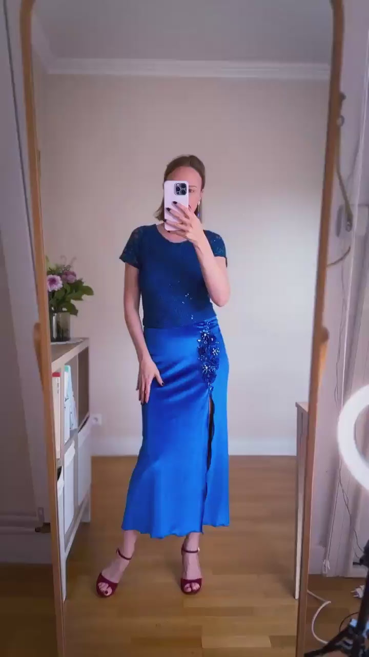 Woman wearing a blue velvet tango skirt with embroidery