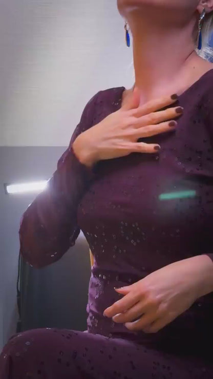 Video of a woman wearing an elegant bordeaux tango dress