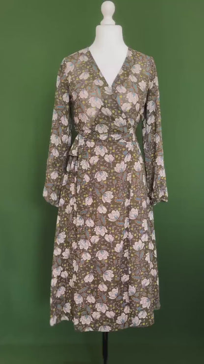 Feminine green wrap dress with flowing skirt and romantic details