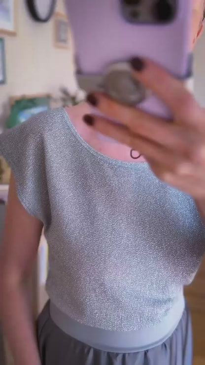 Video of a woman in silver shimmer tango top and grey tango skirt