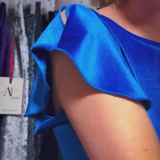 Close-uo of a woman wearing a blue velvet tango dress