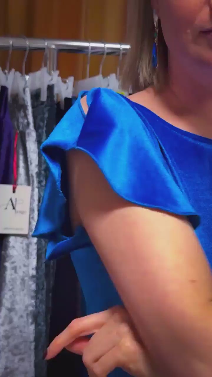 Close-uo of a woman wearing a blue velvet tango dress