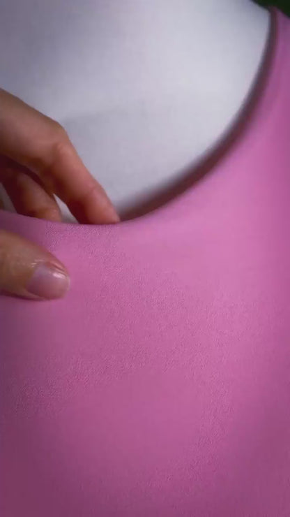 Graceful pink jersey dress with lace detail and flowing silhouette