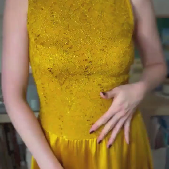 Video of a woman wearing a golden tango dress with shimmering bodice