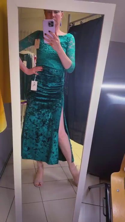 Woman in teal velvet tango skirt looking at the mirror